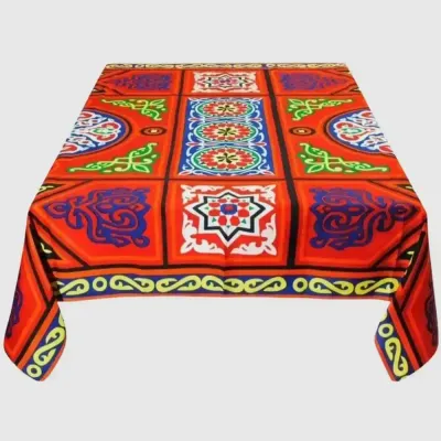 Egyptian Khayameya Ramadan tablecloth in red and blue with gold trim, spread on a dining table in a UAE home during iftar