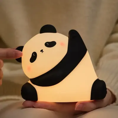 Cute panda night light glowing with warm white light on a child's bedside table in a Dubai nursery at night