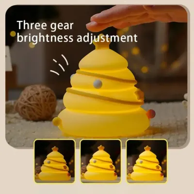 Cute Christmas tree night light glowing with warm white light on a child’s bedside table in a Dubai home during holiday season
