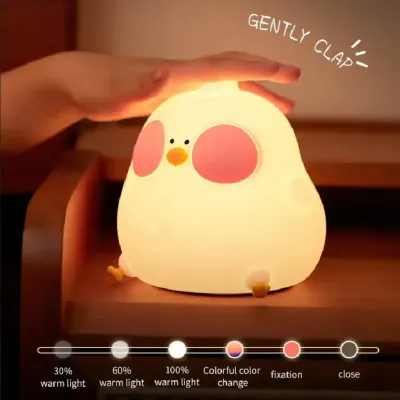 Cute CUCKOO chick night light glowing with warm white light on a baby’s changing table in a Dubai nursery